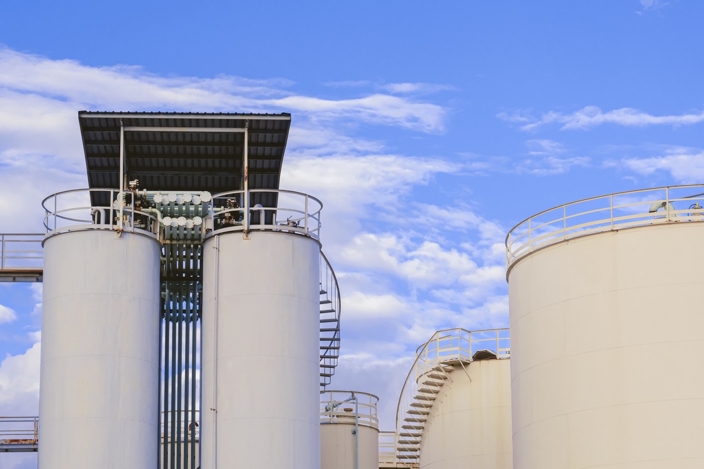 Bulk fuel storage tanks with access stairways and transfer pipework