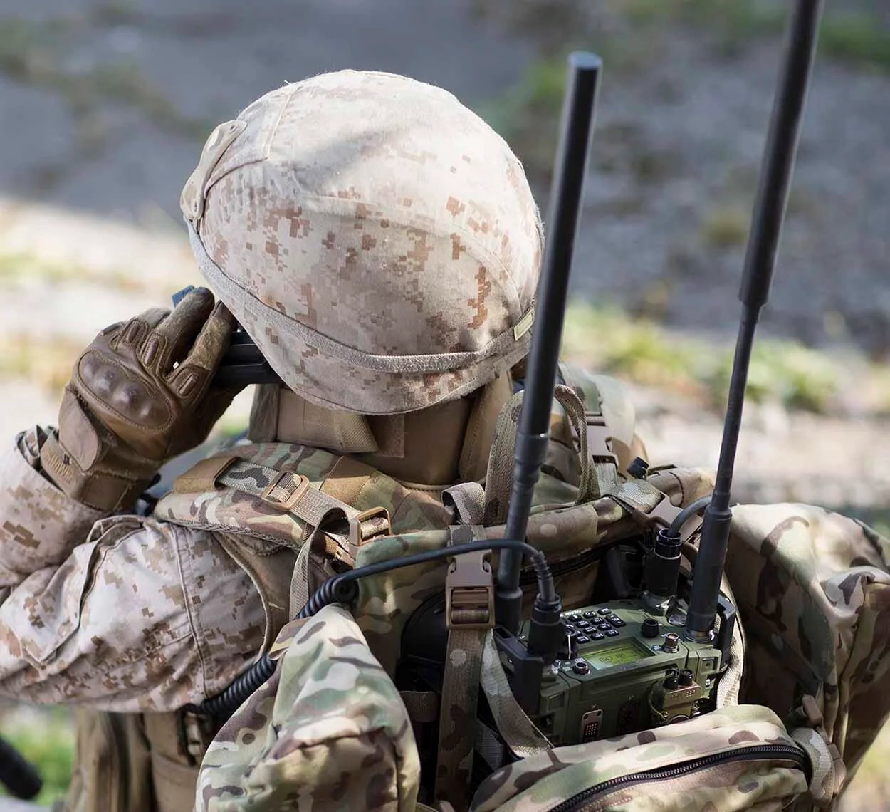 Soldier operating tactical communications equipment